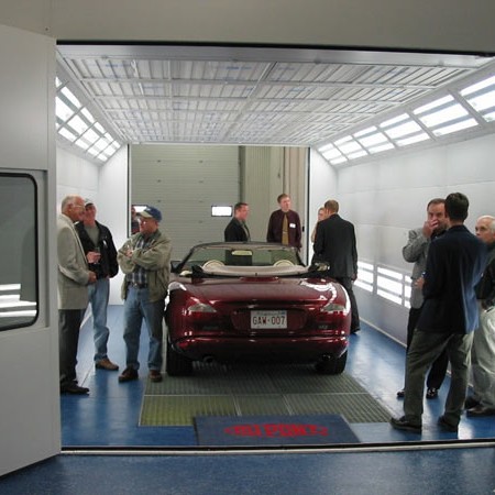 Body Shop Facility in Moncton: Red Jaguar in Paint Booth